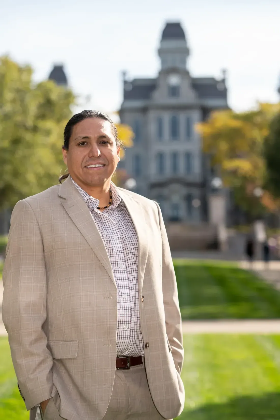 Neil Powless standing in front of the Hall of Languages.